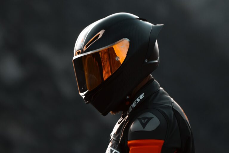 black and orange helmet on black motorcycle