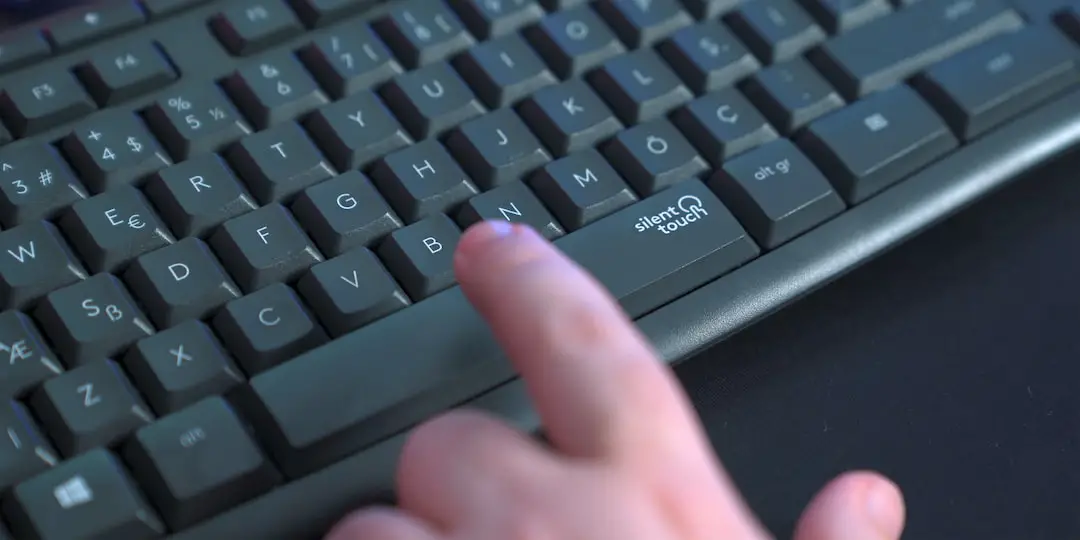 a person pressing a button on a keyboard