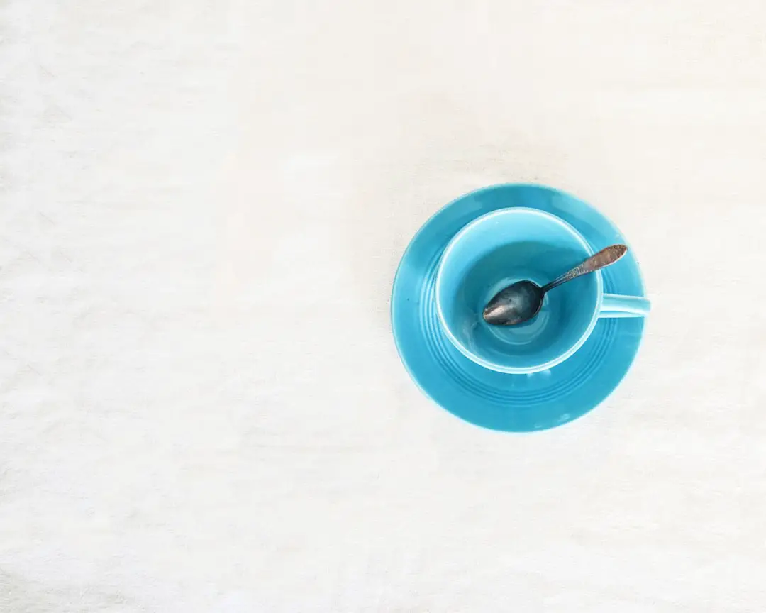 a blue bowl with a spoon inside of it