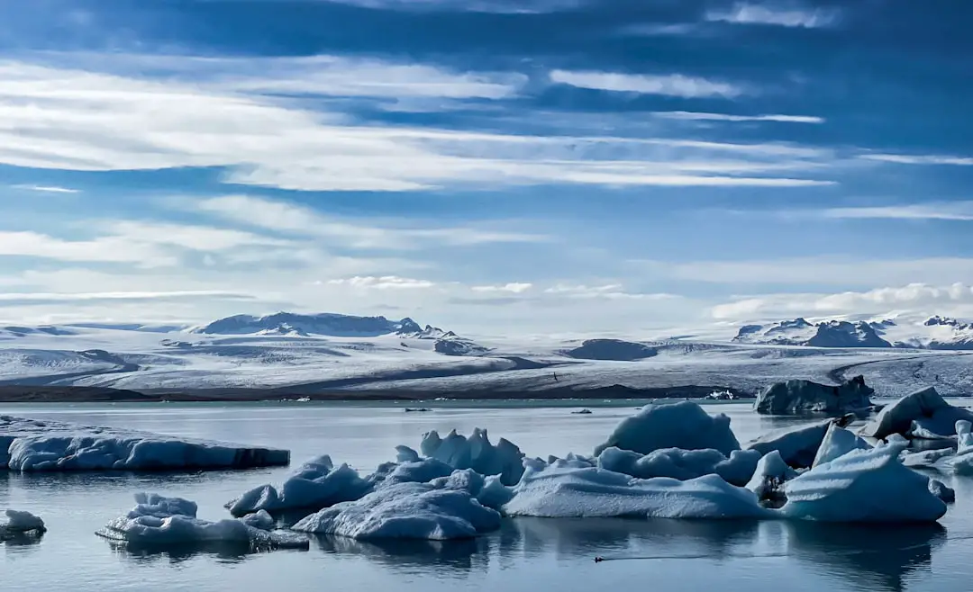 a group of icebergs floating on top of a lake