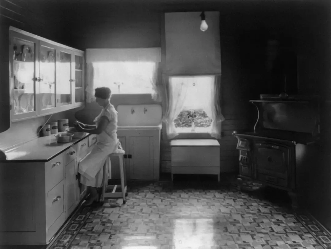Woman peeling potatoes in modern farm kitchen
